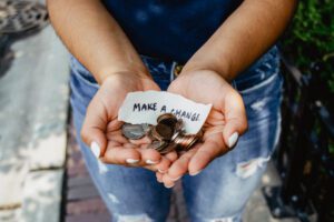 hands with coins and a chit of make change