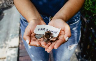 hands with coins and a chit of make change